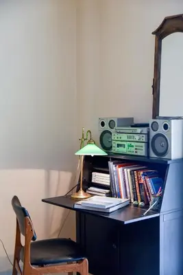 a desk with a lamp and a chair and books at Homie Apartment next to Acropolis in Athens