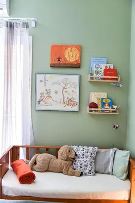 a teddy bear sitting on a bed in a room at Homie Apartment next to Acropolis in Athens