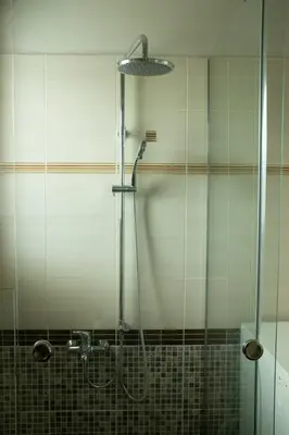 a shower with a glass door in a bathroom at Luxury heated pool Villa in Lagonissi