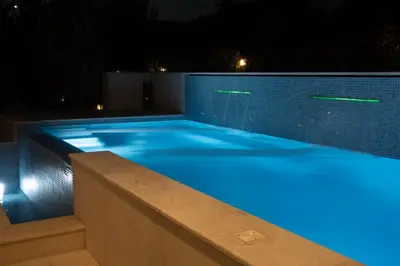 a swimming pool at night with blue lights at Luxury heated pool Villa in Lagonissi