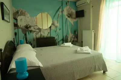 a bedroom with a bed and a wall with flowers at Luxury heated pool Villa in Lagonissi