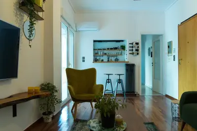 a living room with a yellow chair and a table at A10 SecretHouse in Athens