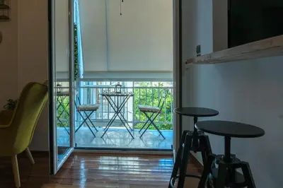 a room with a balcony with two chairs and a table at A10 SecretHouse in Athens