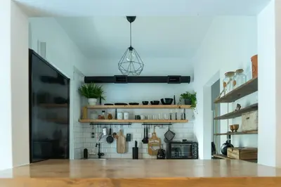 a living room with white walls and wooden shelves at A10 SecretHouse in Athens