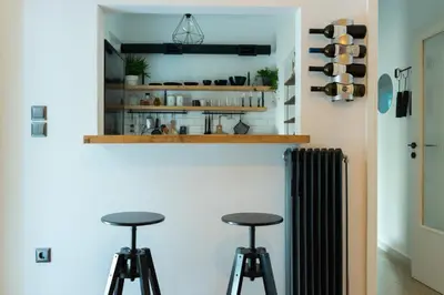 a room with two bar stools and a shelf at A10 SecretHouse in Athens