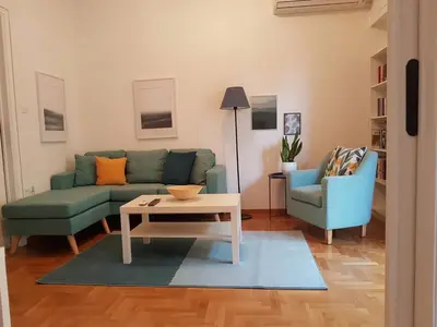 a living room with a couch and two chairs and a table at Colourful Apartment in the heart of Athens in Athens