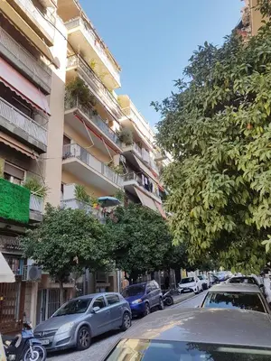 a street with cars parked on the side of a building at Colourful Apartment in the heart of Athens in Athens