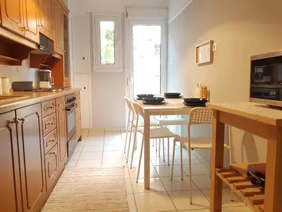 a kitchen with a table and some chairs in it at Colourful Apartment in the heart of Athens in Athens