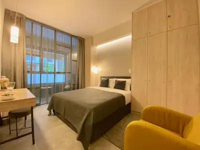 a bedroom with a bed and a table and a couch at 27 times Athens in Athens