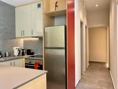 a kitchen with a stainless steel refrigerator at 27 times Athens in Athens