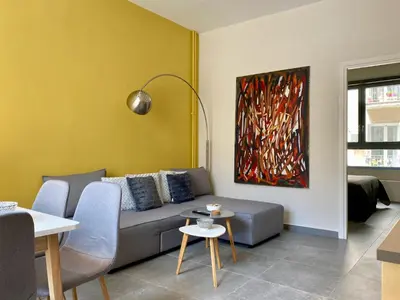 a living room with a couch and a painting at 27 times Athens in Athens