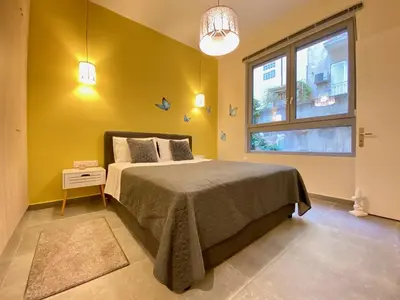 a bedroom with a large bed and a window at 27 times Athens in Athens