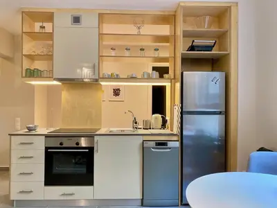 a kitchen with a refrigerator and a table at 27 times Athens in Athens
