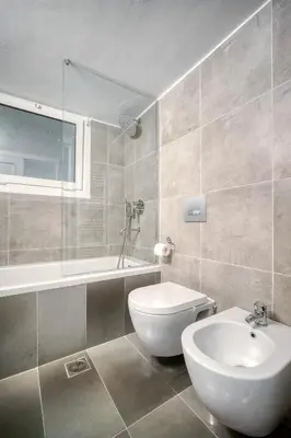 a bathroom with a toilet and a tub and a sink at Bright Spacious Luxury Apartment in Prime Central Athens in Athens