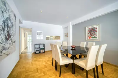 a dining room with a black table and white chairs at Bright Spacious Luxury Apartment in Prime Central Athens in Athens