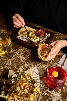 a table with a tray of food and a tray of food at Gatsby Athens in Athens