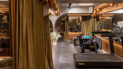 a gym with a curtain and a treadmill at Gatsby Athens in Athens
