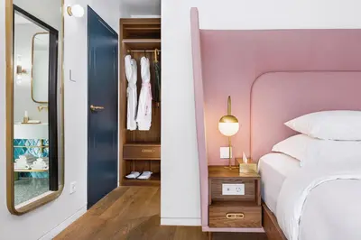 a bedroom with a pink bed and a mirror at Gatsby Athens in Athens