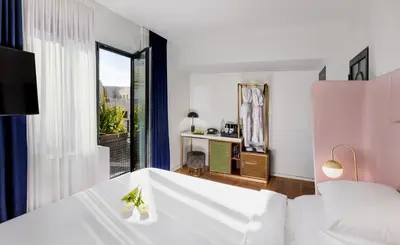 a bedroom with a bed and a large window at Gatsby Athens in Athens