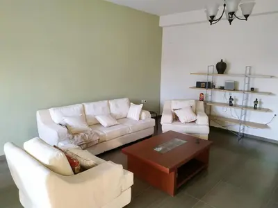 a living room with two couches and a coffee table at Pantazopoulou square apartment (central railway) in Athens