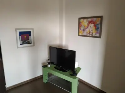 a flat screen tv sitting on a table in a room at Pantazopoulou square apartment (central railway) in Athens
