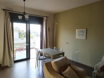 a living room with a table and a couch at Pantazopoulou square apartment (central railway) in Athens