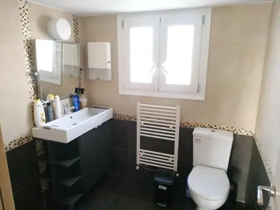 a bathroom with a toilet and a sink and a window at Pantazopoulou square apartment (central railway) in Athens