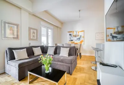 a living room with a couch and a table at Lovely Sunlit Central Athens 2 Bedroom 2 Bathroom Condo in Athens