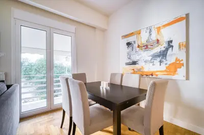 a dining room with a table and chairs at Lovely Sunlit Central Athens 2 Bedroom 2 Bathroom Condo in Athens
