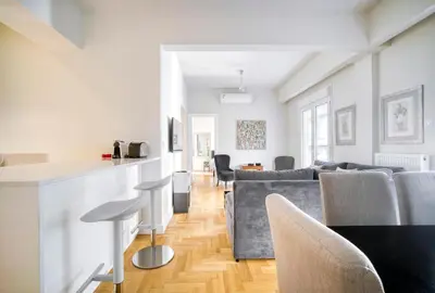 a living room with a couch and a table at Lovely Sunlit Central Athens 2 Bedroom 2 Bathroom Condo in Athens