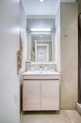 a bathroom with a sink and a mirror at Lovely Sunlit Central Athens 2 Bedroom 2 Bathroom Condo in Athens