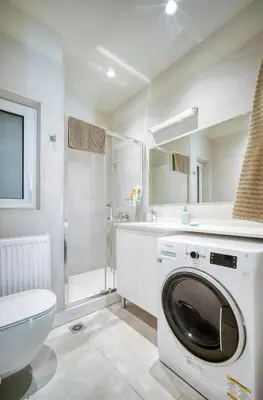 a washing machine in a bathroom with a shower at Lovely Sunlit Central Athens 2 Bedroom 2 Bathroom Condo in Athens