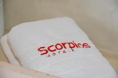 a white towel with the word scodejad written on it at Scorpios Sea Side Hotel in Piraeus