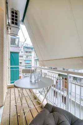 a white table and chairs on a balcony at Delightful Stylish Two Bedroom Condo in Hip Area of Central Athens in Athens