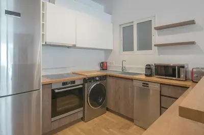 a kitchen with a stainless steel refrigerator and a dishwasher at Delightful Stylish Two Bedroom Condo in Hip Area of Central Athens in Athens