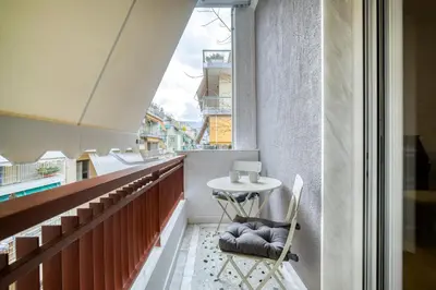 a small balcony with a table and a chair at Stunning Central 180m2 4 Bedroom 3 Bathroom, Sleeps 10 Guests in Athens