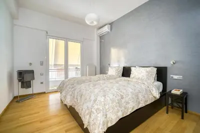 a bedroom with a large bed and a television at Stunning Central 180m2 4 Bedroom 3 Bathroom, Sleeps 10 Guests in Athens