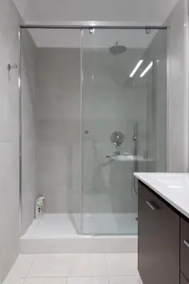 a shower with a glass door in a bathroom at Stunning Central 180m2 4 Bedroom 3 Bathroom, Sleeps 10 Guests in Athens