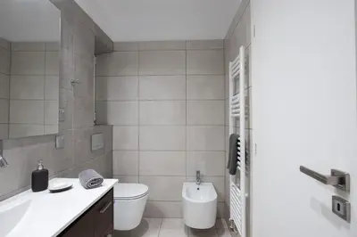 a bathroom with a toilet and a sink and a tub at Stunning Central 180m2 4 Bedroom 3 Bathroom, Sleeps 10 Guests in Athens