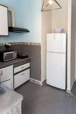 a kitchen with a white refrigerator and a microwave at Vasilis Thissio Petralona 3d floor 55sqm in Athens
