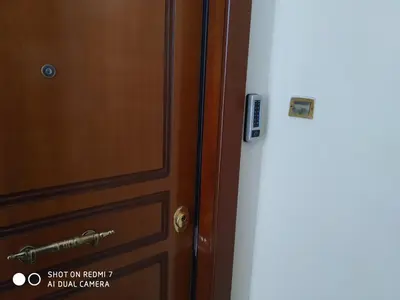 a door with a sign on it next to another door at Vasilis Thissio Petralona 3d floor 55sqm in Athens