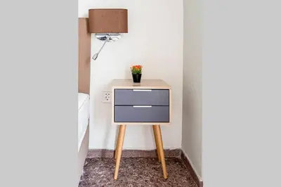 a small table with a drawer and a lamp at Vasilis Thissio Petralona 3d floor 55sqm in Athens