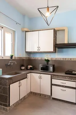 a kitchen with a sink and a microwave at Vasilis Thissio Petralona 3d floor 55sqm in Athens