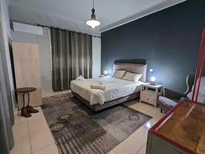 a bedroom with a bed and a blue wall at Rock, few steps from Acropolis rocks! in Athens