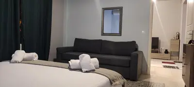 a bedroom with a bed and a couch at Rock, few steps from Acropolis rocks! in Athens