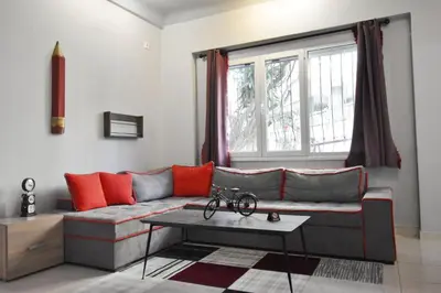 a living room with a couch and a table at Rock, few steps from Acropolis rocks! in Athens
