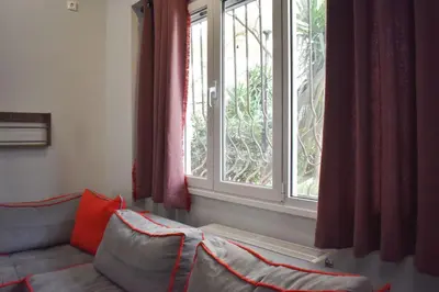 a living room with a couch and a window at Rock, few steps from Acropolis rocks! in Athens