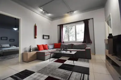 a living room with a couch and a table at Rock, few steps from Acropolis rocks! in Athens