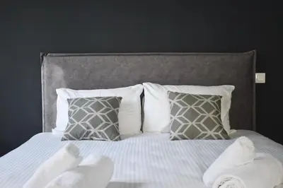 a bedroom with a bed with white towels on it at Rock, few steps from Acropolis rocks! in Athens