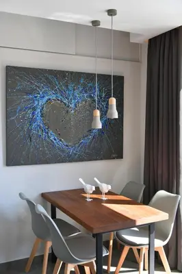a dining room table with chairs and a heart painting at ATHENS PHOS Brand New Loft in Historical Athens Historical Center in Athens